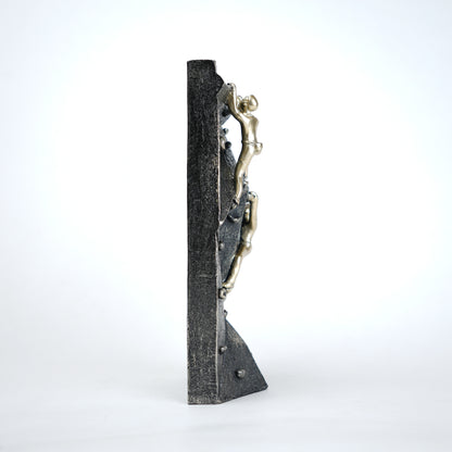 modern climbing figurine with gold climbers on textured rock base for home and office decor