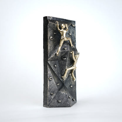 modern climbing figurine with gold climbers on textured rock base for home and office decor