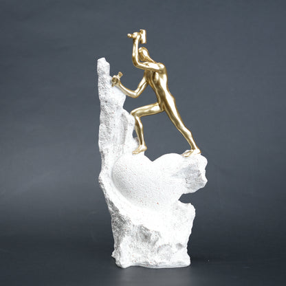 Teamwork climber figurine with gold figures pushing metallic sphere on textured rock base in black and white variants