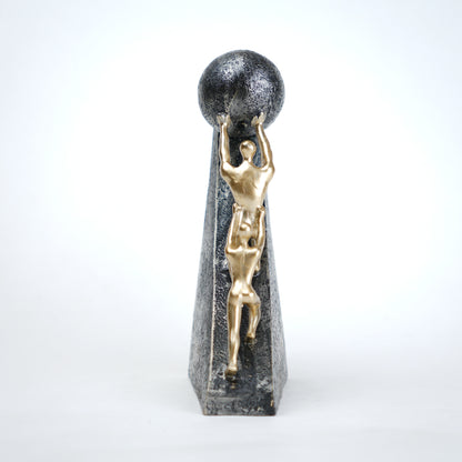 Mountain climber leadership sculpture with gold figurines guiding metallic sphere on textured stone base in black and white variants
