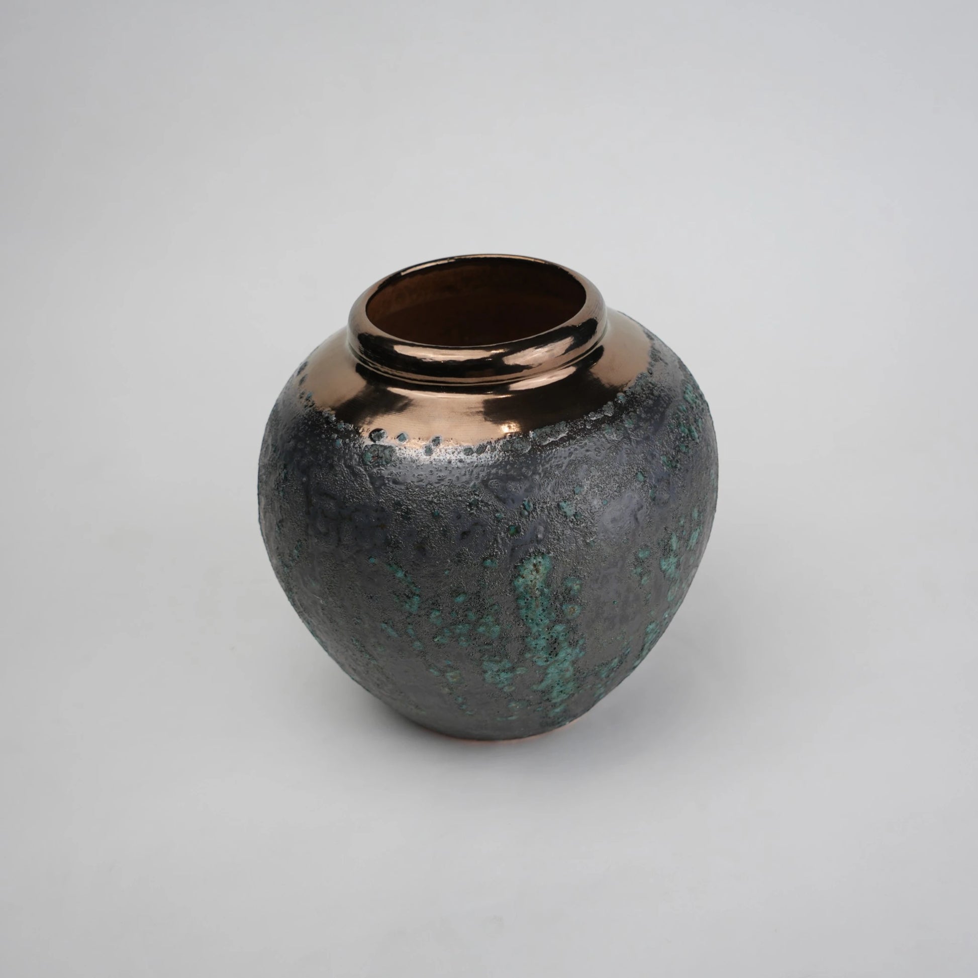green charcoal ceramic vase with patina texture and bronze neck