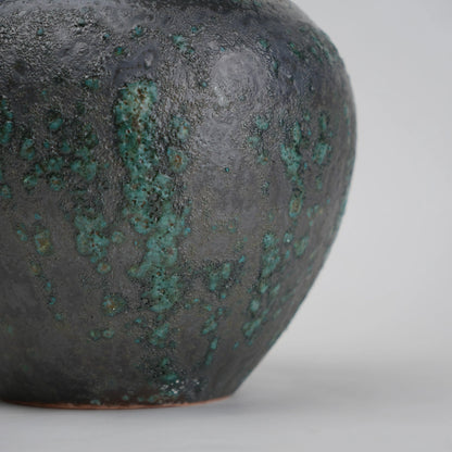green charcoal ceramic vase with patina texture and bronze neck