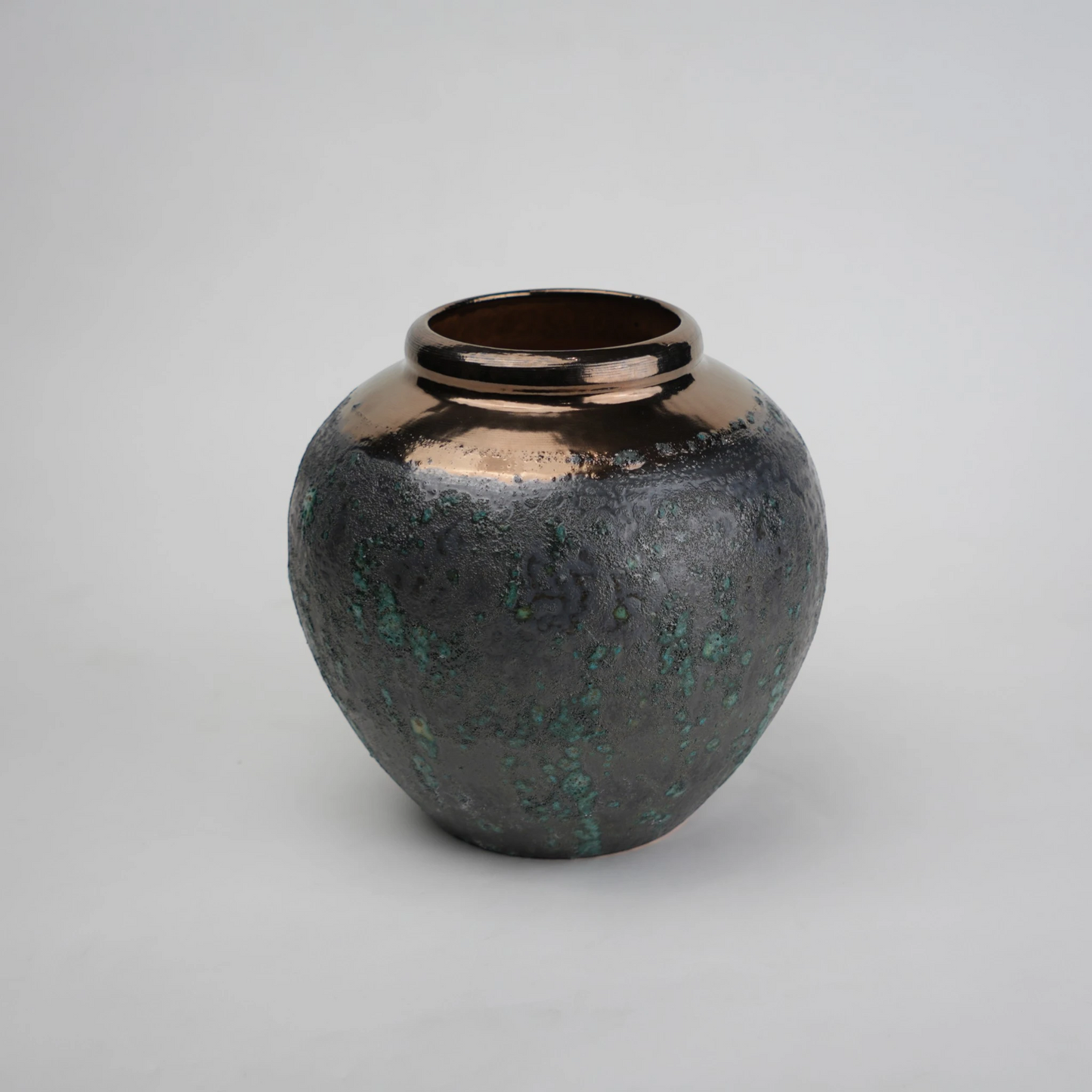 green charcoal ceramic vase with patina texture and bronze neck