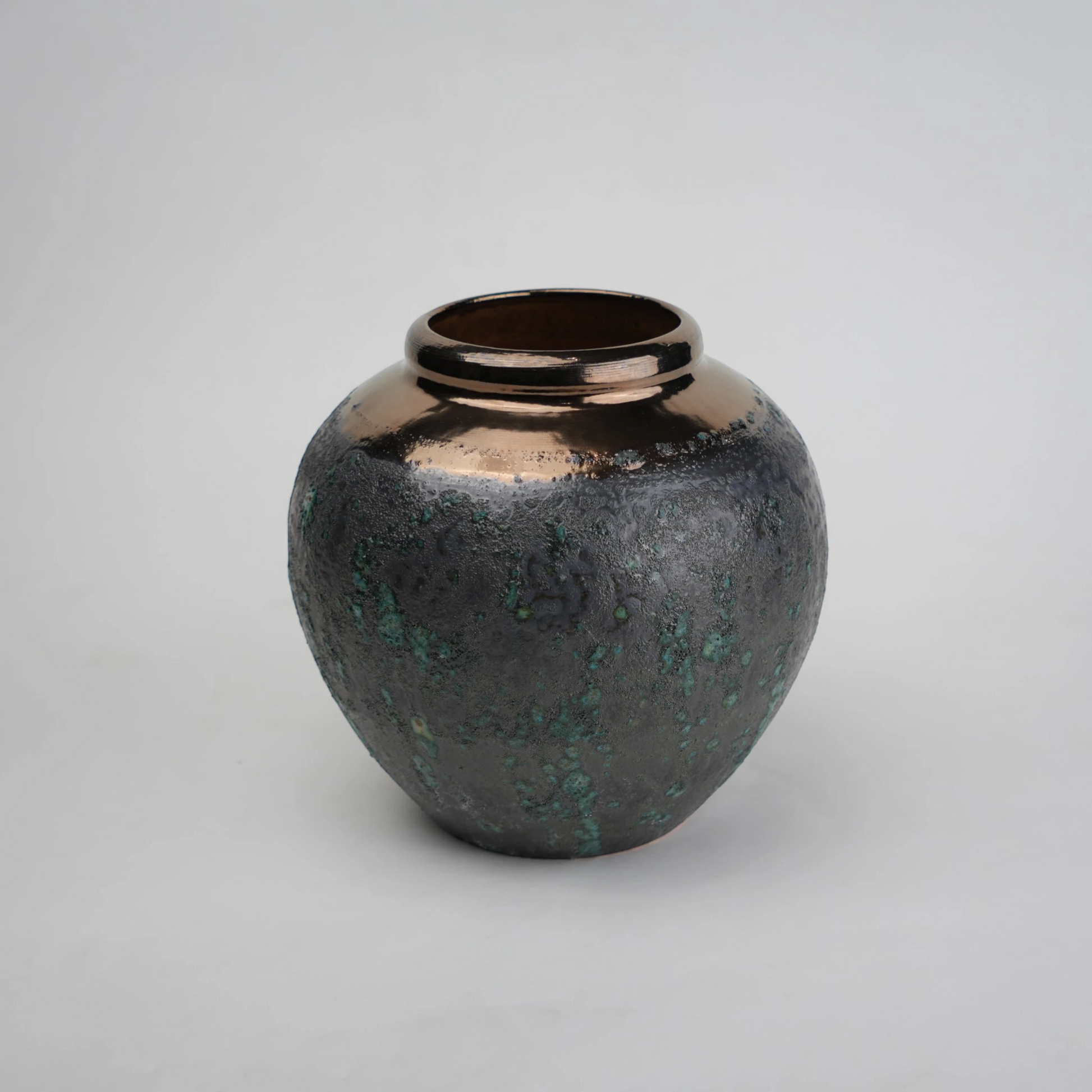green charcoal ceramic vase with patina texture and bronze neck