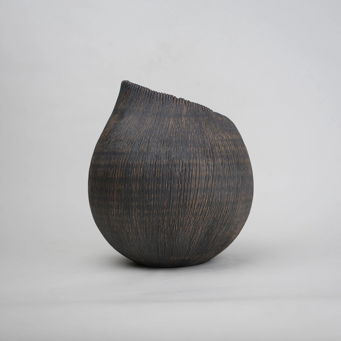 textured charcoal ceramic vase with angled rim
