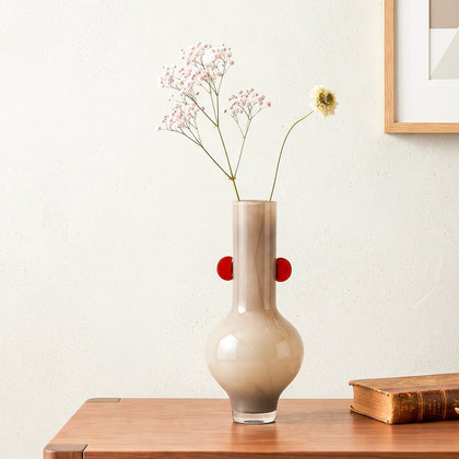 beige glass vase with amber side accents