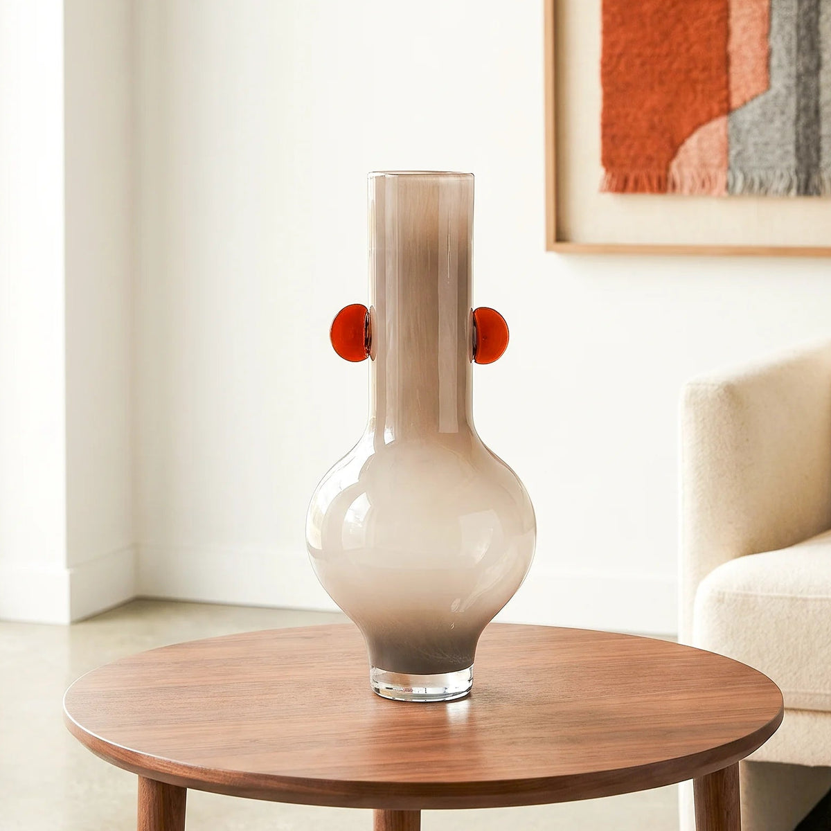 beige glass vase with amber side accents