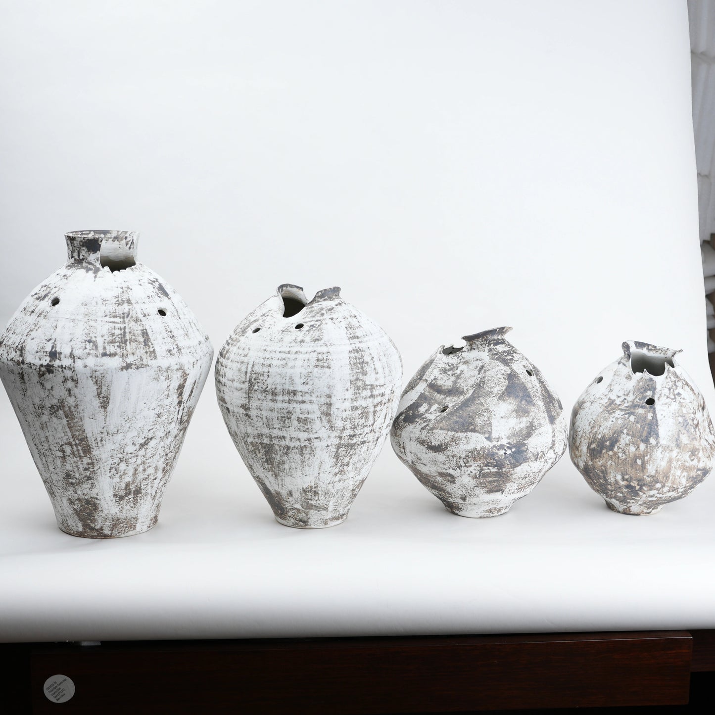 Four distressed ceramic vases