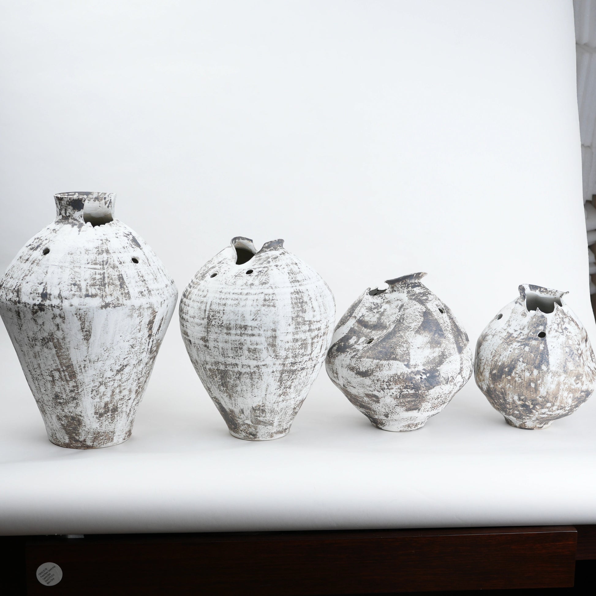 Four distressed ceramic vases