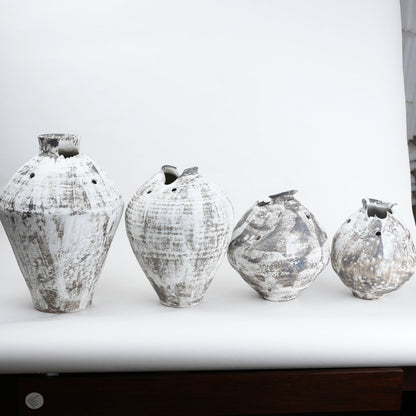 Four distressed ceramic vases