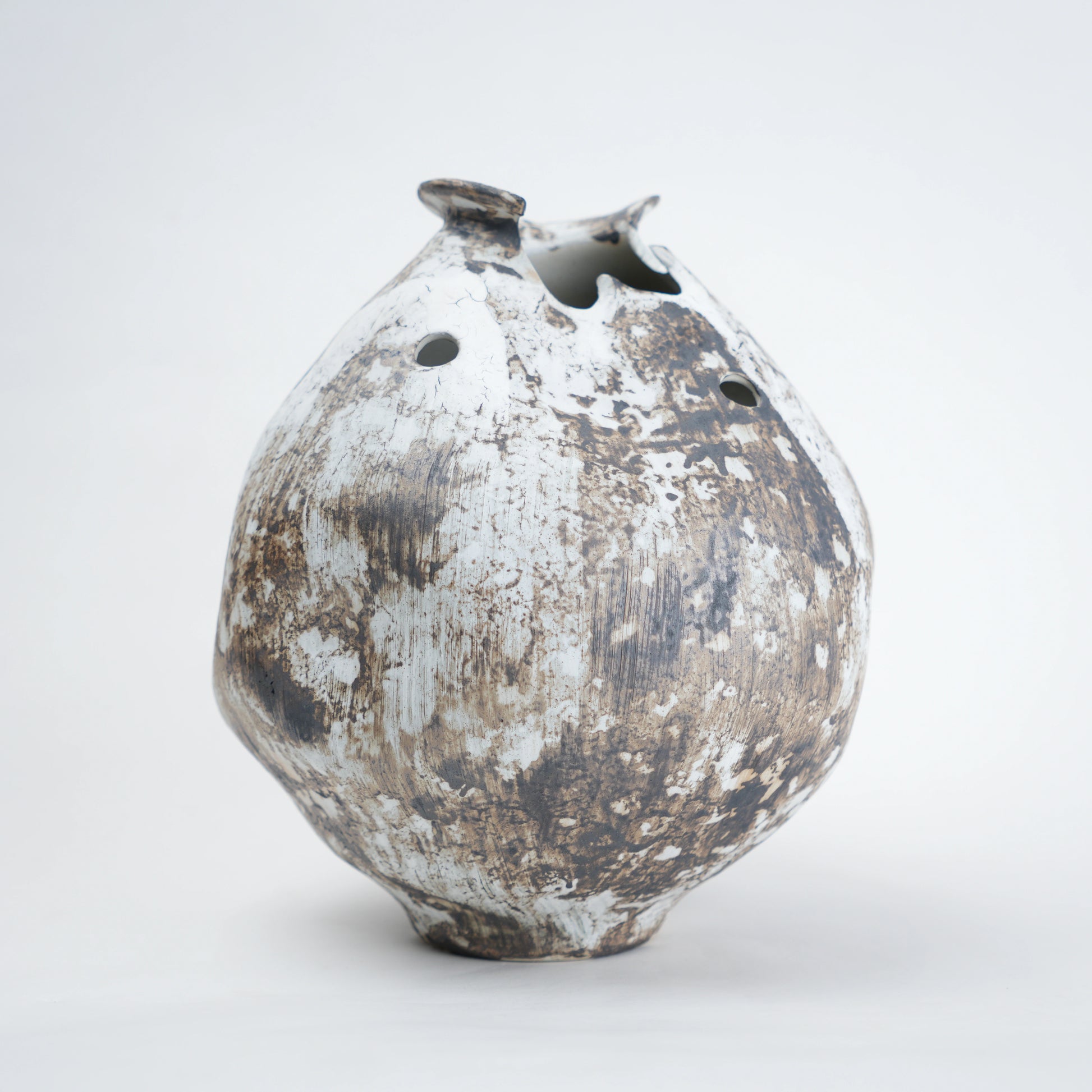 Distressed ceramic vase on a white background
