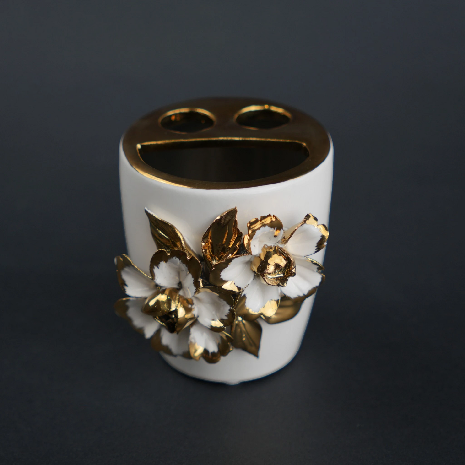 White ceramic holder cup with gold floral detailing for bathroom and desk organization