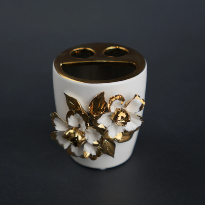 White ceramic holder cup with gold floral detailing for bathroom and desk organization
