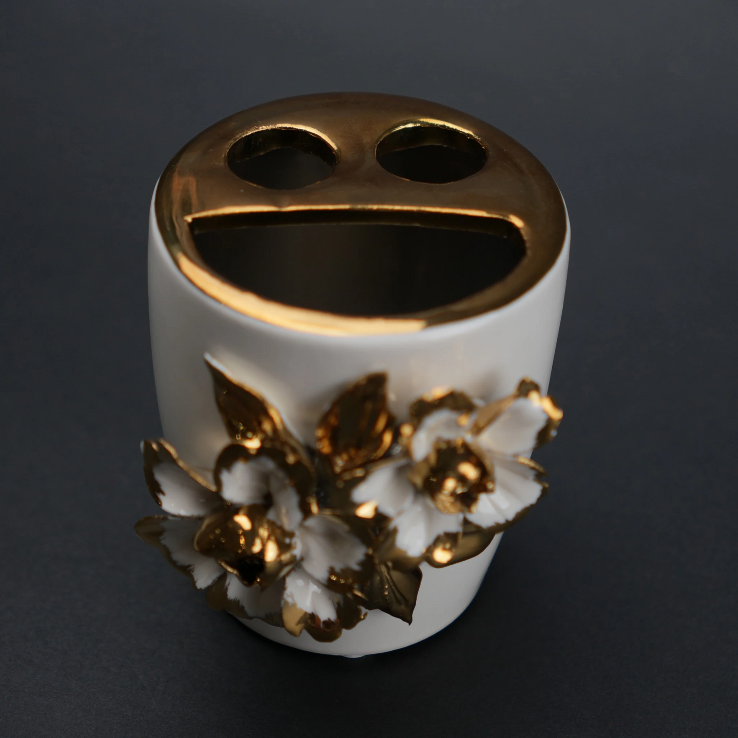 White ceramic holder cup with gold floral detailing for bathroom and desk organization