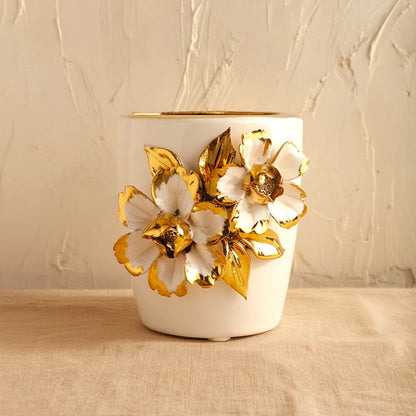 White ceramic holder cup with gold floral detailing for bathroom and desk organization