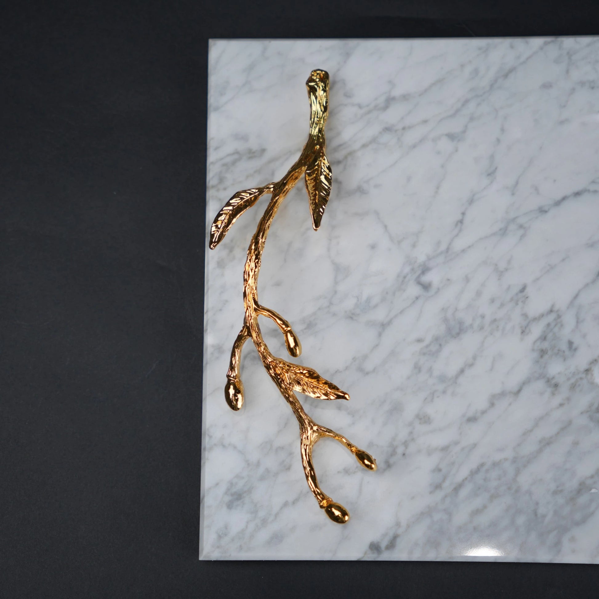 White marble serving platter with gold branch handles for luxury dining and table styling