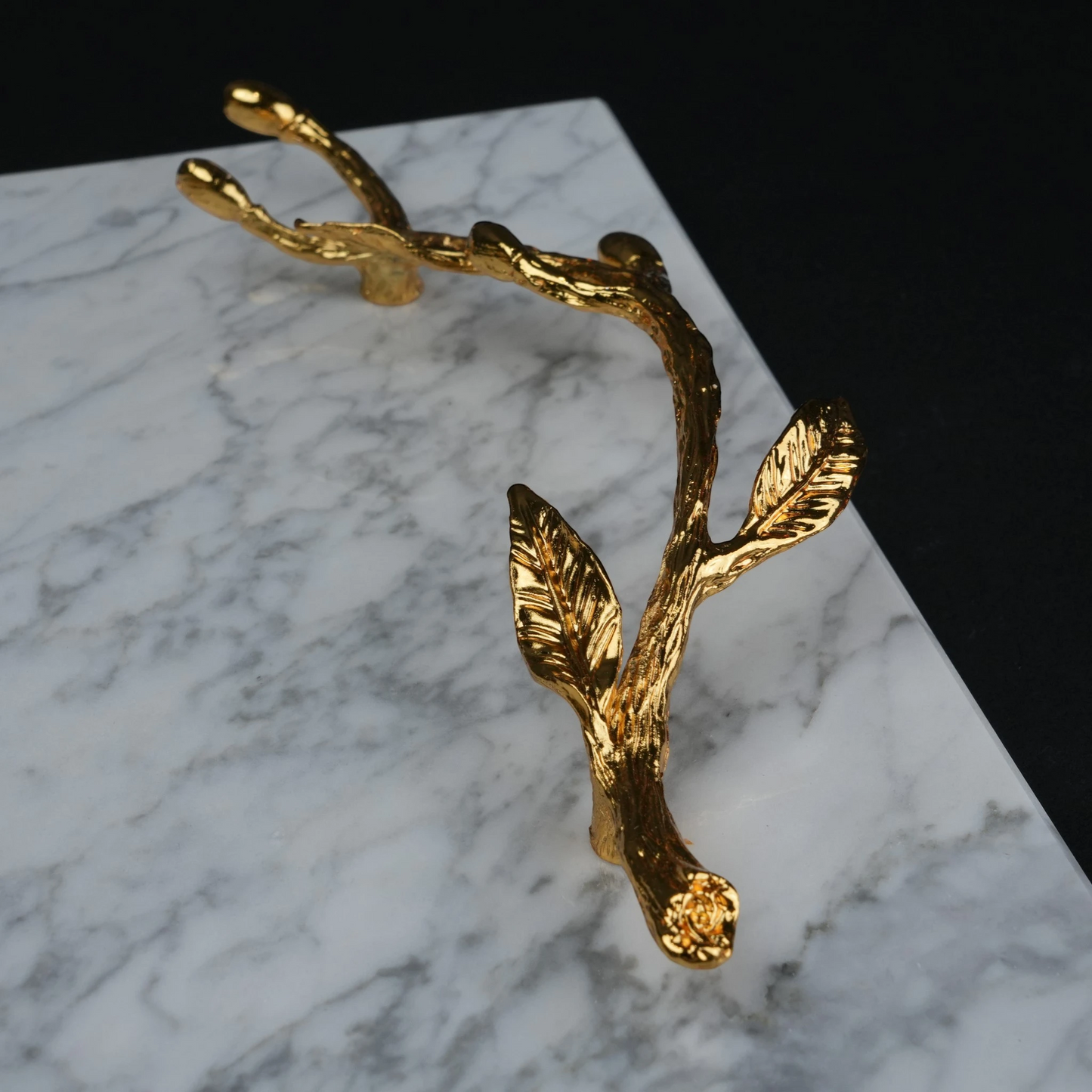 White marble serving platter with gold branch handles for luxury dining and table styling