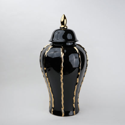 Black ceramic decorative jar with gold flowing accents and lid