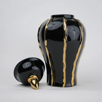 Black ceramic decorative jar with gold flowing accents and lid
