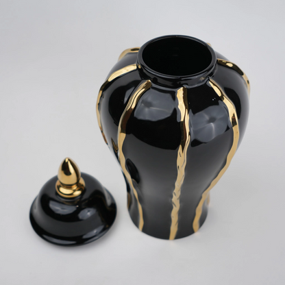 Black ceramic decorative jar with gold flowing accents and lid