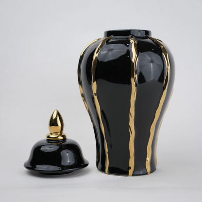 Black ceramic decorative jar with gold flowing accents and lid