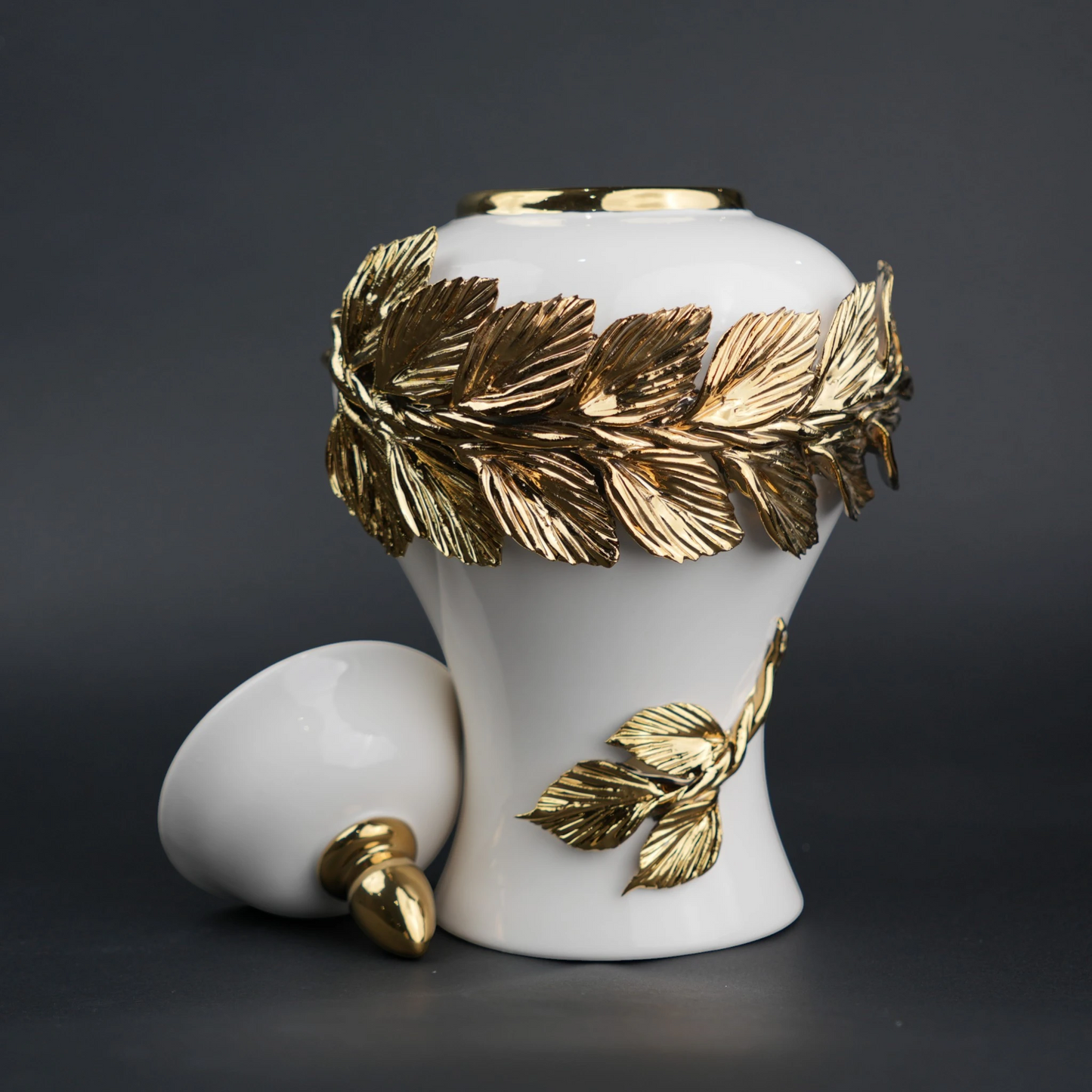 White ceramic decorative jar with gold laurel leaf band and lid