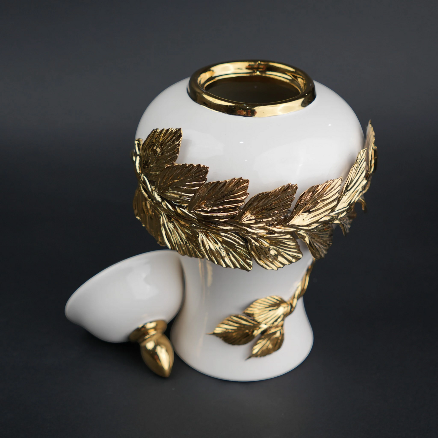 White ceramic decorative jar with gold laurel leaf band and lid