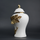 White ceramic decorative jar with gold laurel leaf band and lid