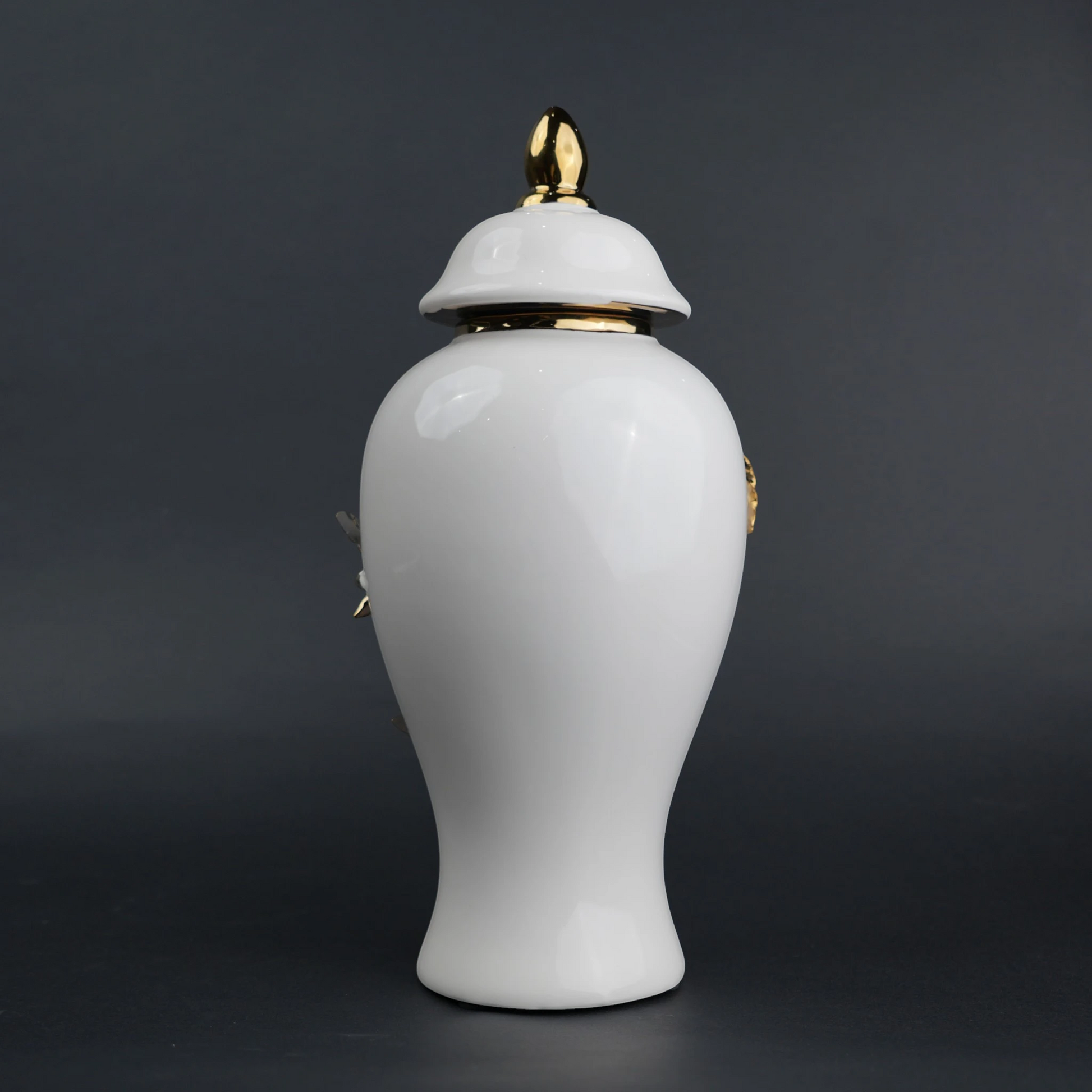 White ceramic decorative jar with sculpted gold floral design and lid