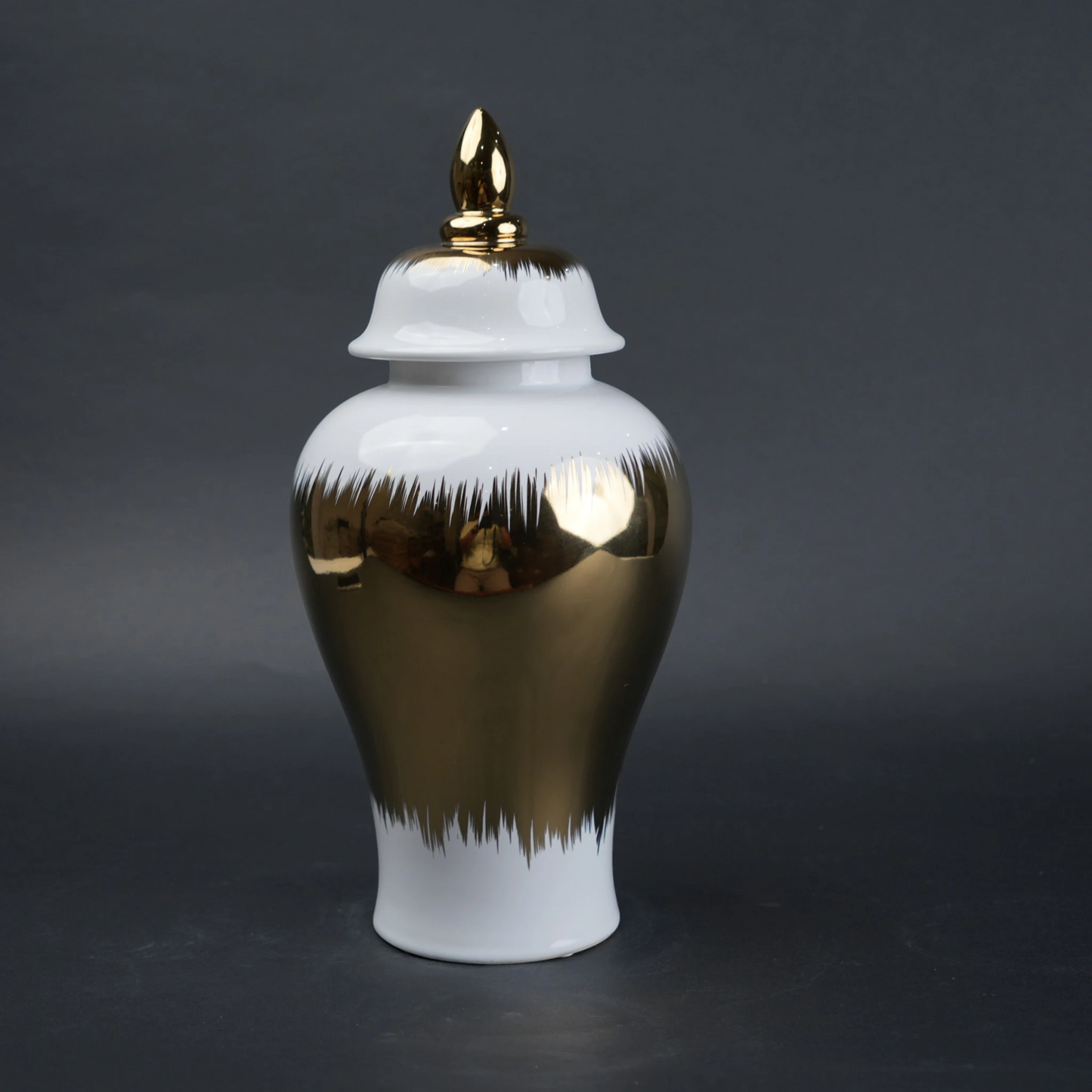 White ceramic decorative jar with gold brush stroke accents and lid