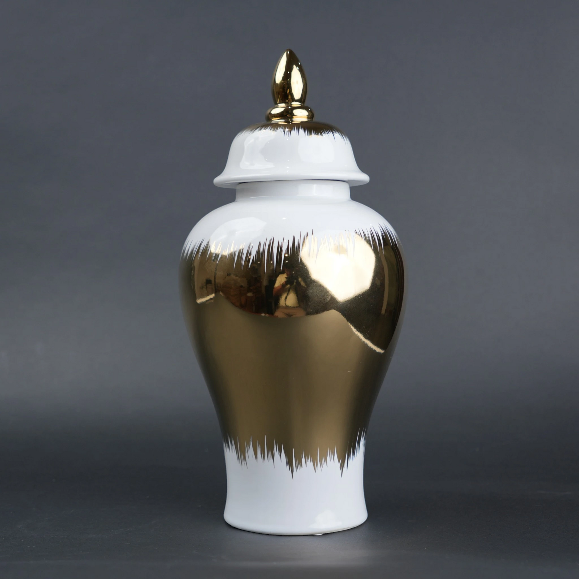 White ceramic decorative jar with gold brush stroke accents and lid