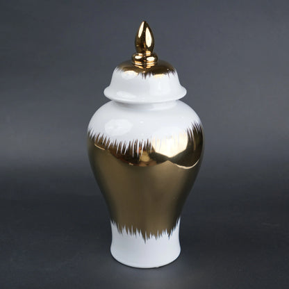 White ceramic decorative jar with gold brush stroke accents and lid