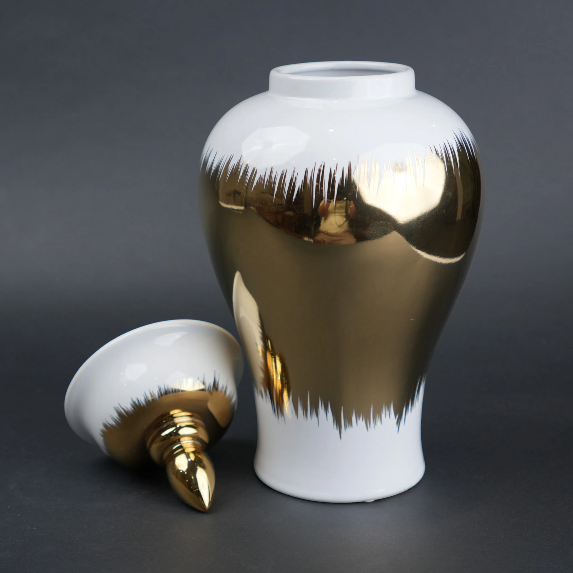 White ceramic decorative jar with gold brush stroke accents and lid