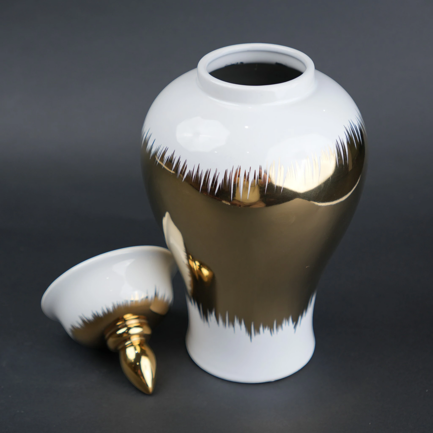 White ceramic decorative jar with gold brush stroke accents and lid