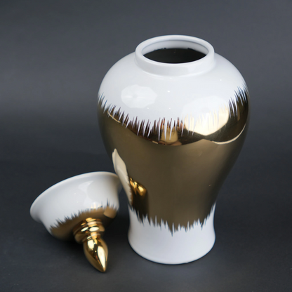 White ceramic decorative jar with gold brush stroke accents and lid