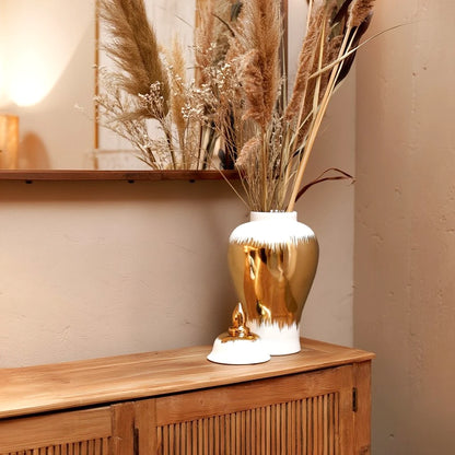 Gilded brush jar w/ pampas on oak credenza