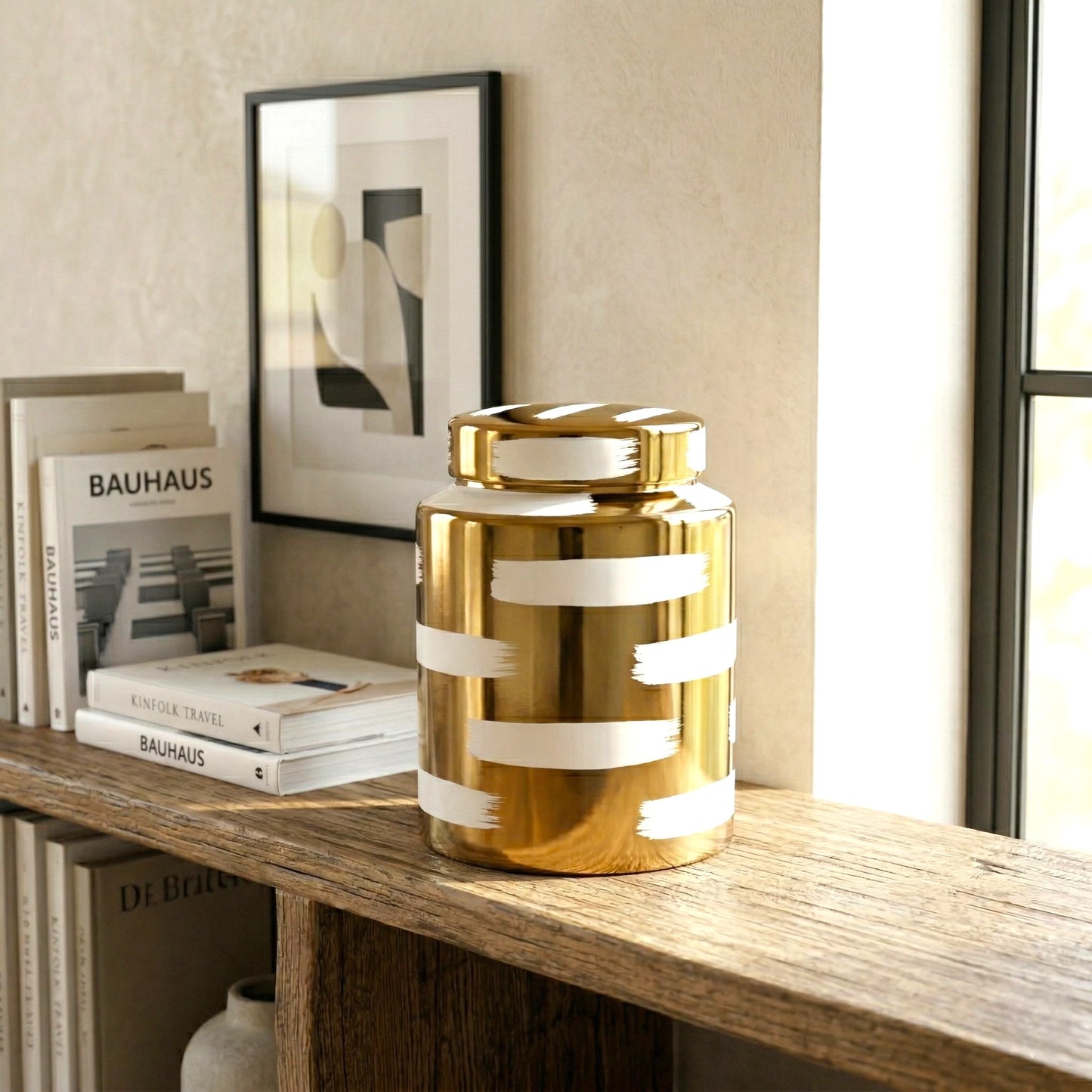 Golden stroke jar on oak shelf w/ books