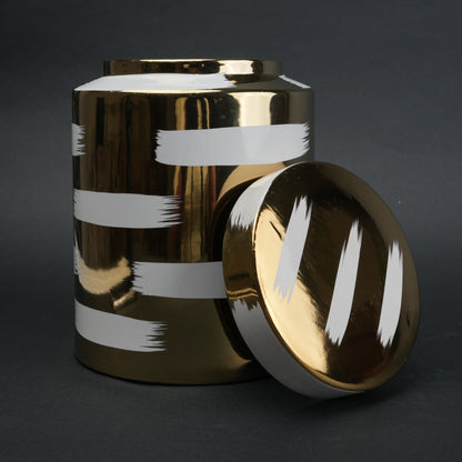 Golden stroke jar on charcoal, lid at side