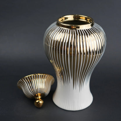 White ceramic jar with gold vertical stripes and lid for luxury home decor styling