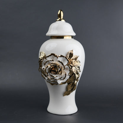 White ceramic jar with gold leaf design and lid