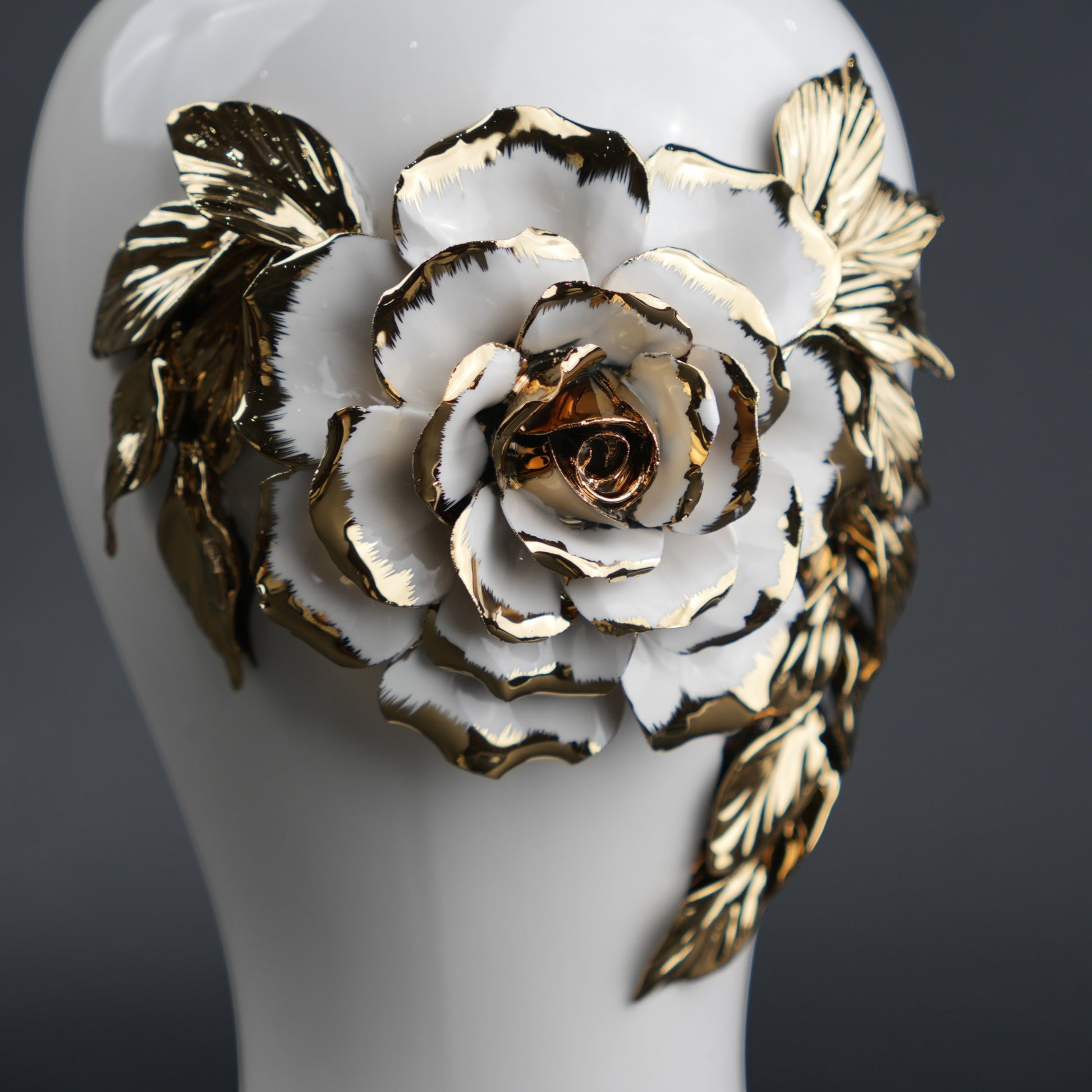 White ceramic jar with gold leaf design and lid