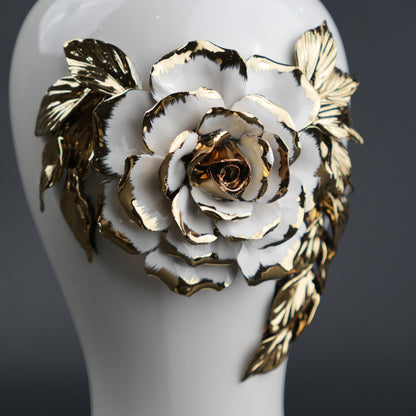 White ceramic jar with gold leaf design and lid
