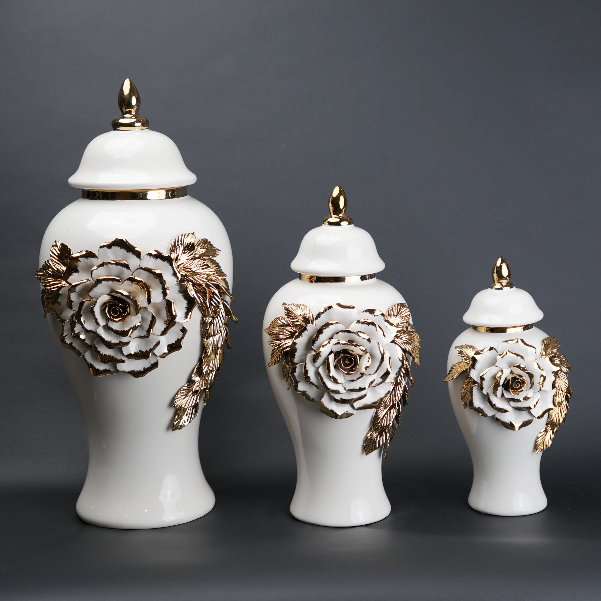White ceramic jar with gold leaf design and lid on a
