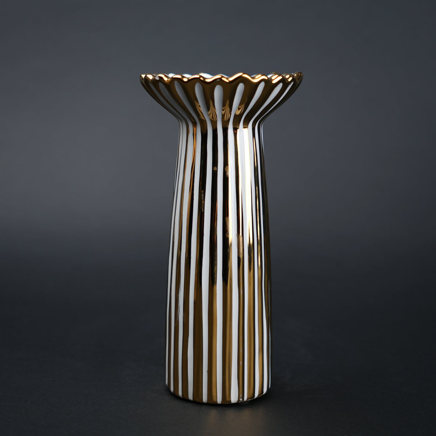 White ceramic candle holder with gold scalloped rim and fluted base for modern home decor styling