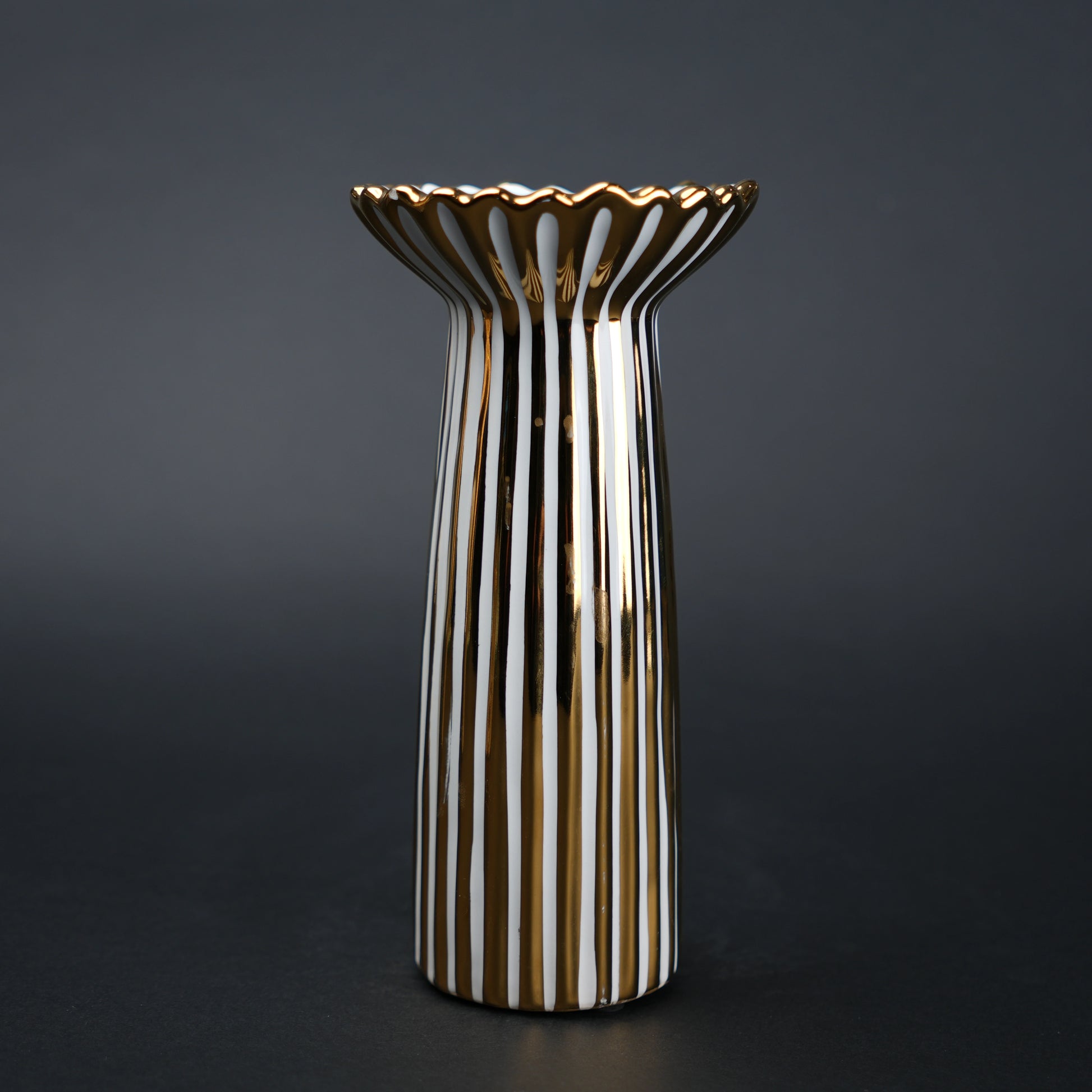 White ceramic candle holder with gold scalloped rim and fluted base for modern home decor styling