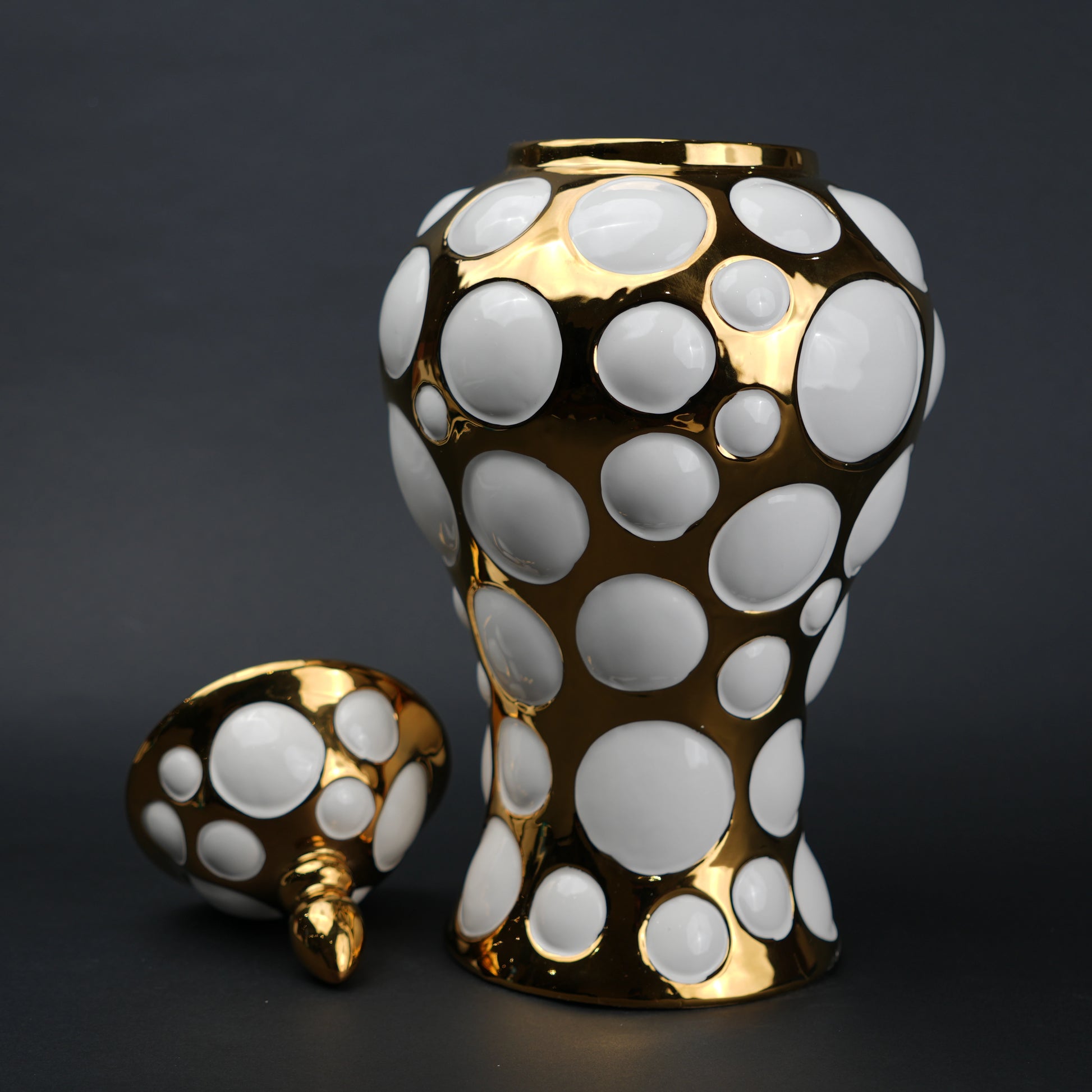 Gold ceramic decorative jar with circular orbit pattern and lid