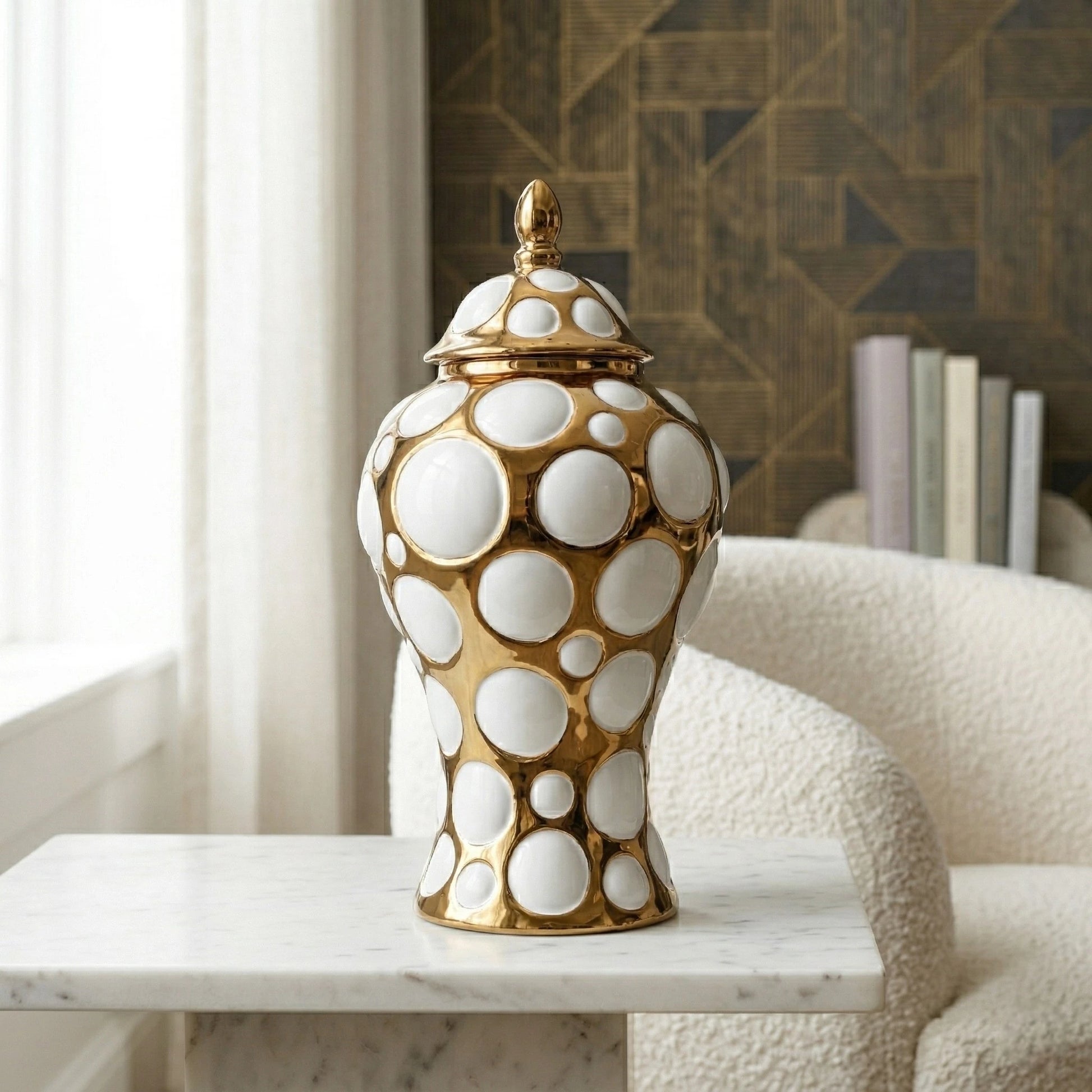 Gilded orbit jar on marble by boucle chair