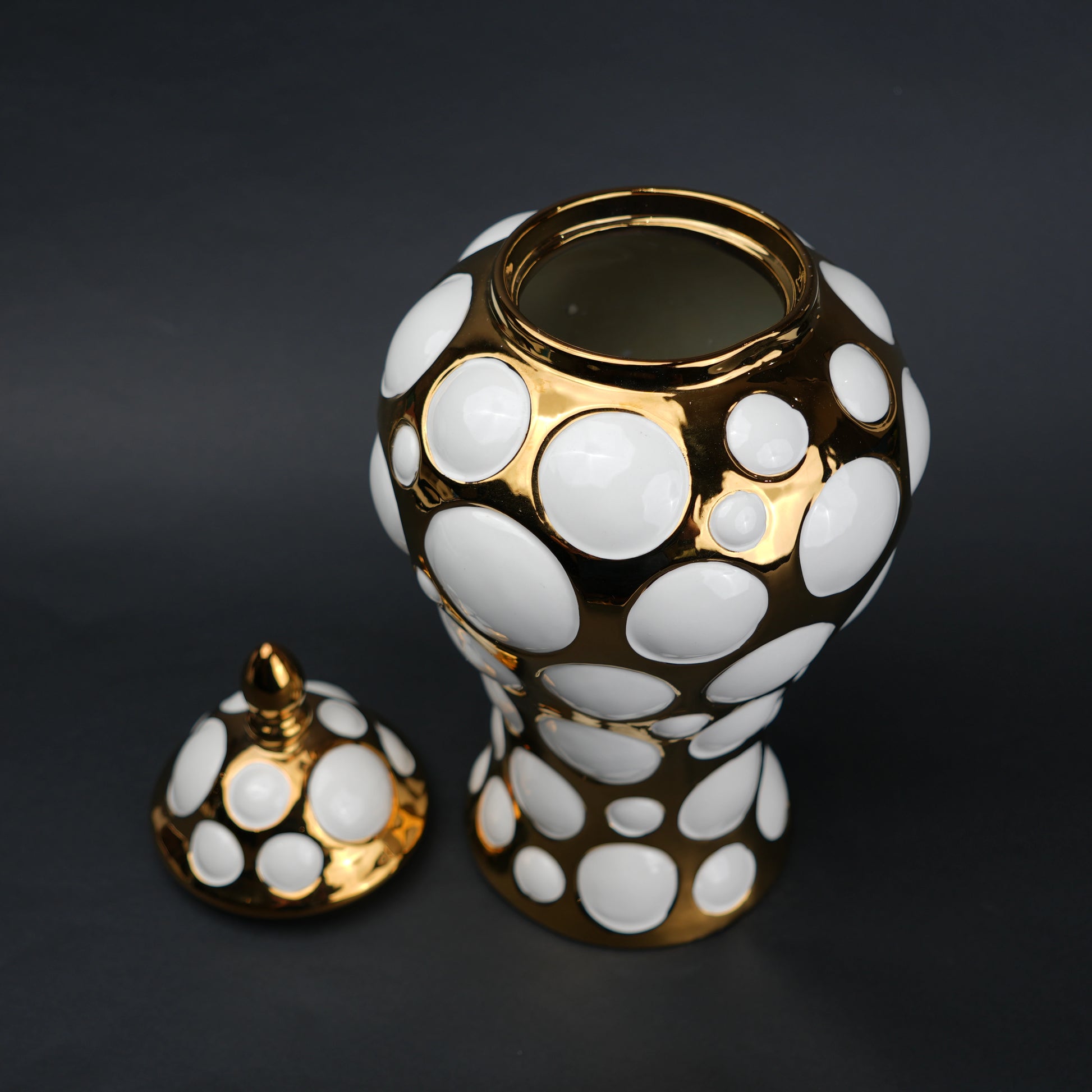 Gold ceramic decorative jar with circular orbit pattern and lid