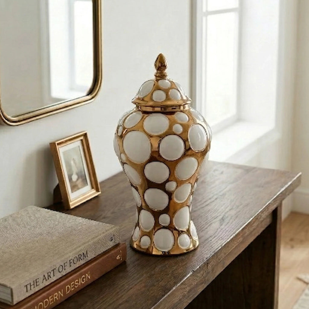 Gilded orbit jar in entry under gilt mirror