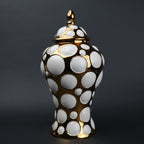 Gold ceramic decorative jar with circular orbit pattern and lid